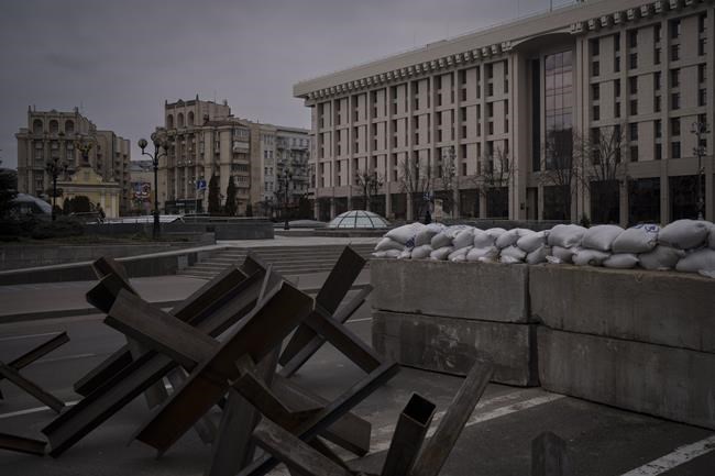 Barricades partially block the main road in front of the Maidan Square, nearly empty during an air raid alarm in Kyiv, Ukraine, Wednesday, March 9, 2022. (AP Photo/Felipe Dana)