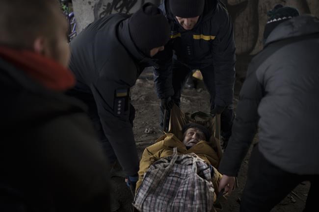 An elderly man is evacuated from Irpin, on the outskirts of Kyiv, Ukraine, Wednesday, March 9, 2022. (AP Photo/Felipe Dana)