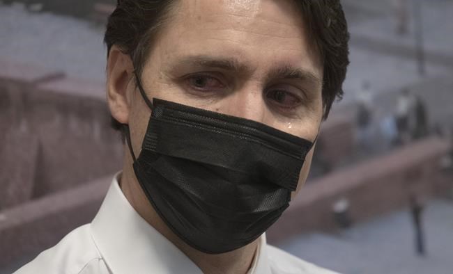 Canadian Prime Minister Justin Trudeau tears up as he listens to a Ukrainian refugee speak during a visit to a refugee centre at a hostel in Warsaw, Poland, Thursday, March 10, 2022. THE CANADIAN PRESS/Adrian Wyld