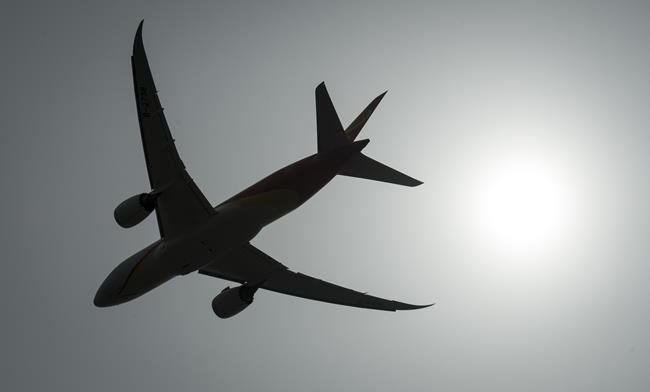 A plane is silhouetted as it takes off from Vancouver International Airport in Richmond, B.C., Monday, May 13, 2019. Airlines are facing a second headwind of skyrocketing oil prices — which could make airfares even more expensive.THE CANADIAN PRESS/Jonathan Hayward