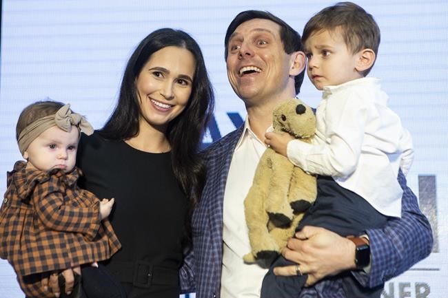 Patrick Brown stands on stage with his wife Genevieve Gualtieri and children Theodore (right) and Savannah as he announces his candidacy for the federal Conservative Leadership at a rally in Brampton, Ont., on Sunday, March 13, 2022. THE CANADIAN PRESS/Chris Young