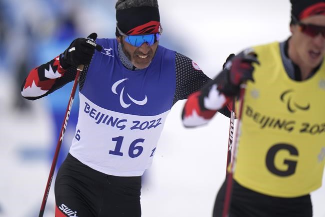 Canada's Brian McKeever and his guide Graham Nishikawa compete during the men's middle distance free technique vision impaired event of para cross country skiing at the 2022 Winter Paralympics, in Zhangjiakou, China, Saturday, March 12, 2022. McKeever is retiring after capturing 20 medals over six Games, many with brother Robin as his guide. THE CANADIAN PRESS/AP-Shuji Kajiyama