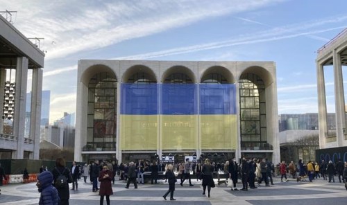 Ukraine's flag is draped outside The Metropolitan Opera House at Lincoln Center for the Performing Arts in New York before a benefit for Ukraine concert, Monday, March 14, 2022. (AP Photo/Ron Blum)