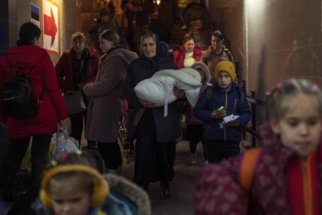 People who fled the war in Ukraine leave Przemysl train station in Przemysl, Poland, Tuesday, March 15, 2022. (AP Photo/Petros Giannakouris)