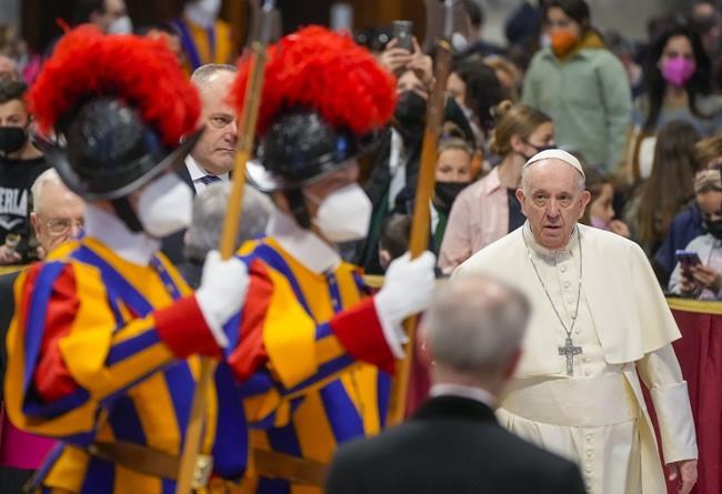 Pope Francis arrives to meet with members of the 'La Zolla' school visiting group in St. Peter's Basilica at The Vatican, before the start of the weekly general audience, Wednesday, March 16, 2022. (AP Photo/ Gregorio Borgia)
