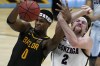 FILE -Baylor forward Flo Thamba (0) fights for a rebound with Gonzaga forward Drew Timme (2) during the first half of the championship game in the men's Final Four NCAA college basketball tournament, Monday, April 5, 2021, at Lucas Oil Stadium in Indianapolis. Thamba, who has a 7-foot-5 wingspan, is originally from the Democratic Republic of the Congo, grew up in South Africa and also lived in England and France before coming to the United States. He looks forward to having his parents in the stands while playing on the biggest stage. (AP Photo/Michael Conroy, File)