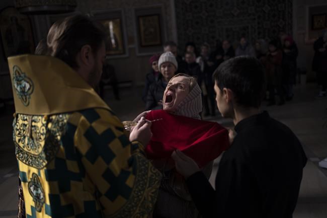 A woman receives communion inside the