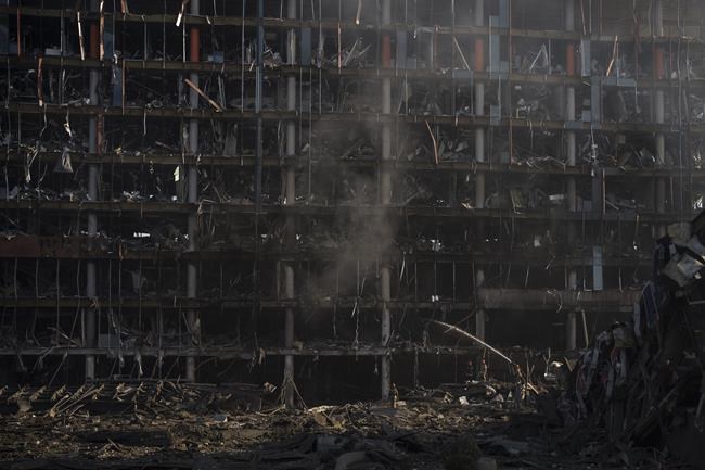 Firefighters extinguish a fire at a shopping center following a bombing in Kyiv, Ukraine, Monday, March 21, 2022. (AP Photo/Felipe Dana)