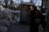 An elderly woman walks pass concrete blocks topped with sandbags at a street in Odesa, southern Ukraine, on Tuesday, March 22, 2022. (AP Photo/Petros Giannakouris)