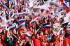 People wave Russian national flags as they gather to attend the concert marking the eighth anniversary of the referendum on the state status of Crimea and Sevastopol and its reunification with Russia, in Moscow, Russia, Friday, March 18, 2022. (Ramil Sitdikov/Sputnik Host Photo Agency pool via AP)
