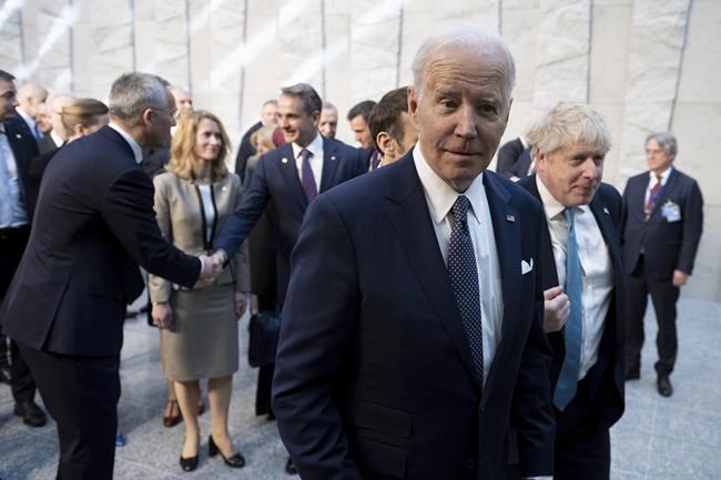 President Joe Biden walks with British Prime Minister Boris Johnson, right, at NATO Headquarters in Brussels, Thursday, March 24, 2022. (Brendan Smialowski, Pool via AP)