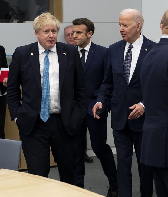President Joe Biden, British Prime Minister Boris Johnson, left, and French President Emmanuel Macron arrive for a meeting of the G7 Leaders' at NATO Headquarters in Brussels, Belgium, Thursday, March 24, 2022. (Doug Mills/The New York Times via AP, Pool)