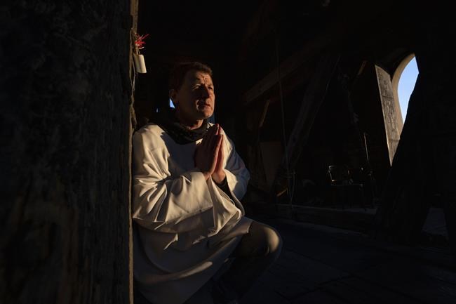 Volodymyr Ilnytskyi, 55, a retired policeman, prays before ringing the bell of the Latin Cathedral in Lviv, western Ukraine, Thursday, March 24, 2022. (AP Photo/Nariman El-Mofty)