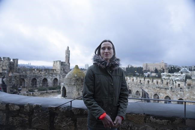 Ukrainian runner Valentyna Veretska poses for a portrait at the Tower of David in Jerusalem's Old City a day before competing in the Jerusalem marathon, Thursday, March 24, 2022.(AP Photo/Maya Alleruzzo)