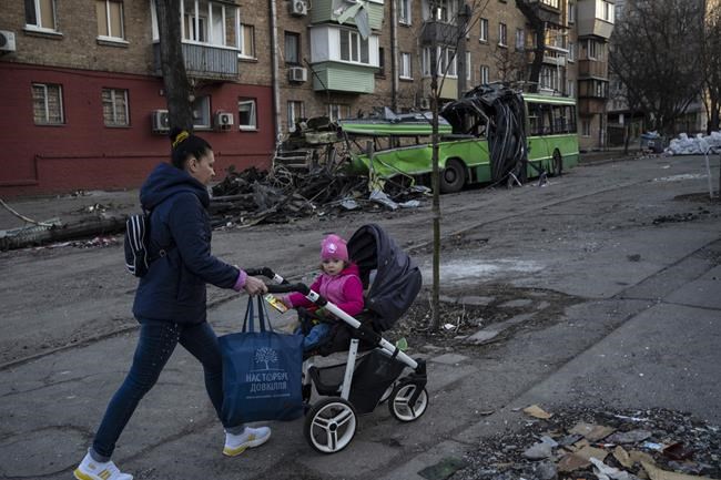Lena Danilova, 39, walks with her daughter Kira, 2, near her house in Podolskyi neighborhood, Kyiv, Ukraine, Friday, March 25, 2022.