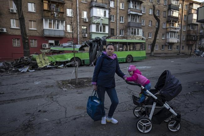 Lena Danilova, 39, walks with her daughter Kira, 2, near her house in Podolskyi neighborhood, Kyiv, Ukraine, Friday, March 25, 2022.