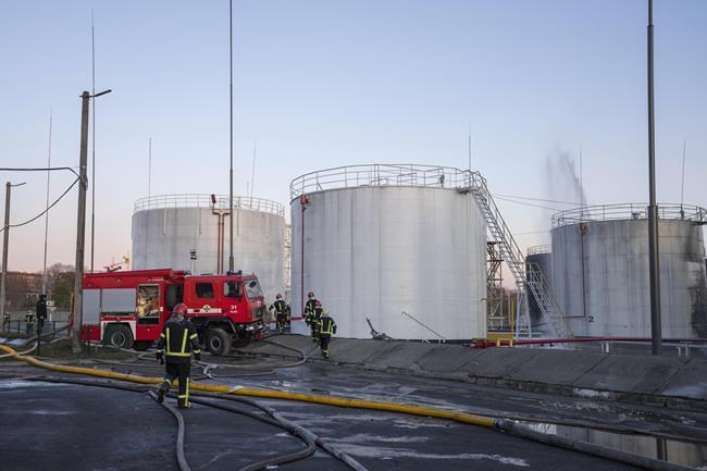 Firefighters work at the site in the aftermath of the first strike that involved Russian rockets that hit an oil facility in an industrial area in the northeastern outskirts of Lviv, Ukraine, Sunday, March 27, 2022. (AP Photo/Nariman El-Mofty)