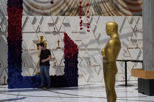 Oscar statues adorn the red carpet during preparations for Sunday's 94th Academy Awards outside the Dolby Theatre Friday, March 25, 2022, in Los Angeles. (AP Photo/John Locher)