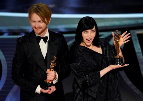 Billie Eilish, right, and Finneas O'Connell accept the award for best original song for 