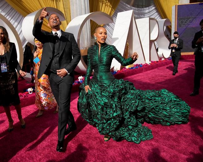 Will Smith, left, and Jada Pinkett Smith arrive at the Oscars on Sunday, March 27, 2022, at the Dolby Theatre in Los Angeles. (AP Photo/John Locher)