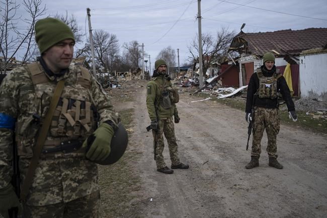 Ukrainian soldiers gather near the front line in Brovary, on the outskirts of Kyiv, Ukraine, Monday, March 28, 2022. (AP Photo/Rodrigo Abd)