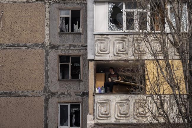 A man sits in a damaged flat of a building after a Russian attack on the previous night, at the residential area in Mikolaiv, Ukraine, on Tuesday, March 29, 2022. Ukrainian President Volodymyr Zelenskyy says seven people were killed in a missile strike on the regional government headquarters in the southern city of Mykolayiv. (AP Photo/Petros Giannakouris)