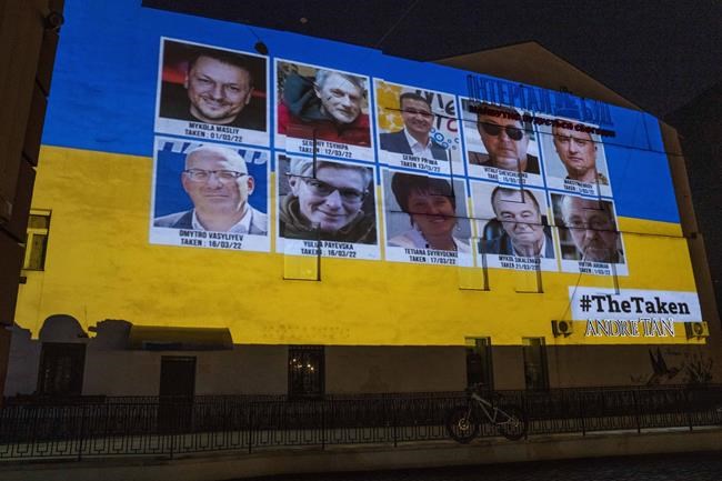 A large-scale projection of Ukrainian people allegedly missing in Russia, projected on a wall in Lviv, western Ukraine, Tuesday, March 29, 2022. (AP Photo/Nariman El-Mofty)