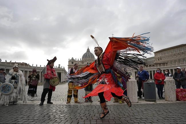 Members of the Assembly of First Nations perform in St. Peter's Square at the Vatican, Thursday, March 31, 2022. Pope Francis has welcomed First Nations delegations to the Vatican. They are seeking an apology for the Catholic Church's role in running Canada's notorious residential schools for Indigenous children. (AP Photo/Alessandra Tarantino)
