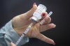 A vaccine is drawn out during a drive-through COVID-19 vaccine clinic in Kingston, Ont., on Sunday, January 2, 2022. The National Advisory Committee on Immunization recommends provinces and territories rapidly prepare to offer second booster doses of COVID-19 vaccines over the coming weeks. THE CANADIAN PRESS/Lars Hagberg