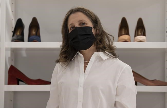 Deputy Prime Minister and Finance Minister Chrystia Freeland speaks with the media after purchasing a new pair of shoes at a local shop, Wednesday, April 6, 2022 in Ottawa. Freeland will deliver the federal budget today. THE CANADIAN PRESS/Adrian Wyld