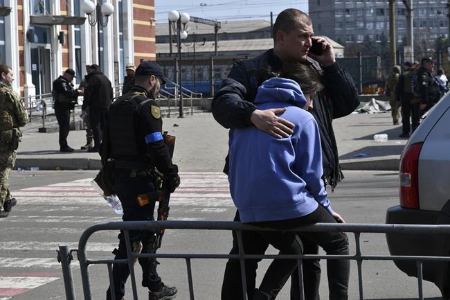A man hugs a woman after Russian shelling at the railway station in Kramatorsk, Ukraine, Friday, April 8, 2022. Hours after warning that Ukraine's forces already had found worse scenes of brutality in a settlement north of Kyiv, President Volodymyr Zelenskyy said that “thousands” of people were at the station in Kramatorsk, a city in the eastern Donetsk region, when it was hit by a missile. (AP Photo/Andriy Andriyenko)