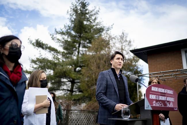 Prime Minister Justin Trudeau speaks about Budget 2022 highlights from a podium in a family home's backyard in Hamilton, Ont., Friday, April 8, 2022. THE CANADIAN PRESS/Peter Power