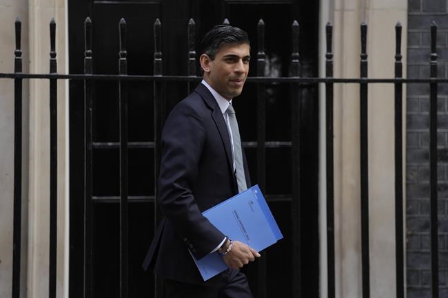 FILE - Rishi Sunak, Britain's Chancellor of the Exchequer poses for the media as he leaves 11 Downing Street in London, Wednesday, March 23, 2022. U.K. Prime Minister Boris Johnson’s office says he will be issued a fine for breaching COVID-19 regulations following allegations of lockdown parties at government offices. Treasury Chief Rishi Sunak will also be fined. (AP Photo/Alastair Grant, File)