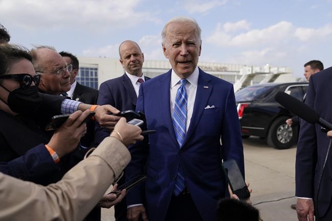 President Joe Biden speaks to reporters before boarding Air Force One at Des Moines International Airport, in Des Moines Iowa, Tuesday, April 12, 2022, en route to Washington. Biden said that Russia's war in Ukraine amounted to a