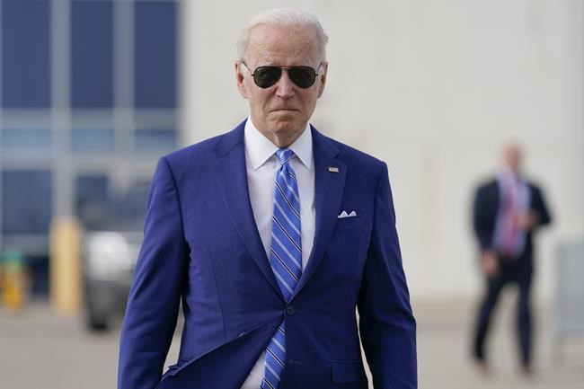 President Joe Biden walks to speak to reporters before boarding Air Force One at Des Moines International Airport, in Des Moines Iowa, Tuesday, April 12, 2022, en route to Washington. Biden said that Russia's war in Ukraine amounted to a