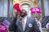 Charles Booker, a candidate for U.S. Senate, joins protesters at the Kentucky state Capitol in Frankfort, Ky., on Wednesday, April 13, 2022. Demonstrators' chants echoed through Kentucky's Capitol as Republican lawmakers started pushing aside the Democratic governor's veto of a bill putting new restrictions on abortion. (Ryan C. Hermens/Lexington Herald-Leader via AP)