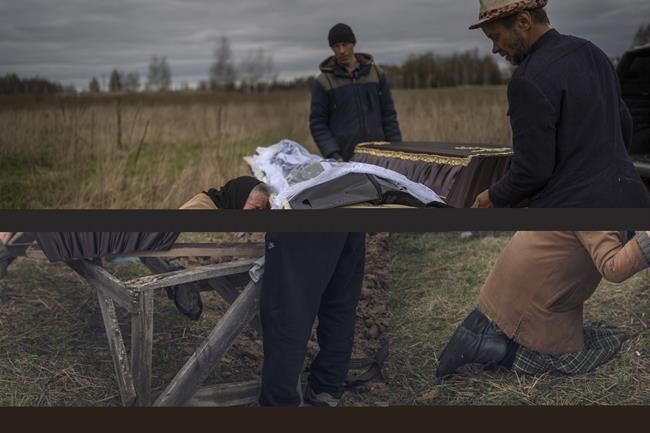 Nadiya Trubchaninova, 70, cries while holding the coffin of her son Vadym, 48, who was killed by Russian soldiers last March 30 in Bucha, during his funeral in the cemetery of Mykulychi, on the outskirts of Kyiv, Ukraine, Saturday, April 16, 2022. After nine days since the discovery of Vadym's corpse, finally Nadiya could have a proper funeral for him. This is not where Nadiya Trubchaninova thought she would find herself at 70 years of age, hitchhiking daily from her village to the shattered town of Bucha trying to bring her son's body home for burial. (AP Photo/Rodrigo Abd)