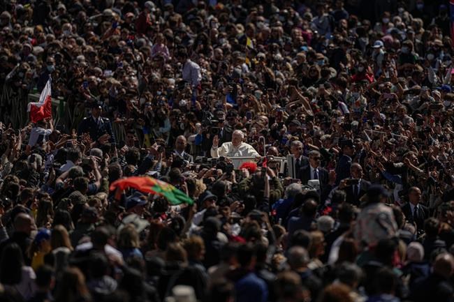 Pope Francis on his popemobile drives through the crowd of faithful at the end of the Catholic Easter Sunday mass he led in St. Peter's Square at the Vatican, Sunday, April 17, 2022. For many Christians, this weekend marks the first time in three years they will gather in person to celebrate Easter Sunday. (AP Photo/Alessandra Tarantino)