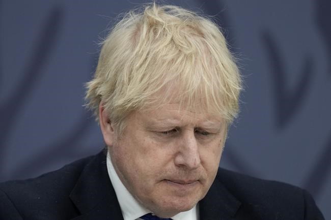 FILE - British Prime Minister Boris Johnson delivers a speech at Lydd Airport, south east England, Thursday, April 14, 2022. Johnson is facing British lawmakers for the first time since he was fined by police for attending a birthday party in his office that broke coronavirus lockdown rules. As the House of Commons returns Tuesday, April 19, 2022 from an 11-day Easter break, Johnson is expected to apologize for what he insists was a minor slip-up. (AP Photo/Matt Dunham, Pool, File)