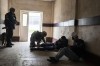 A member of security forces gives first aid to an injured man following a Russian bombing of a factory in Kramatorsk, eastern Ukraine, Tuesday, April 19, 2022, killing at least one person and injuring three others. Russian forces attacked along a broad front in eastern Ukraine on Tuesday as part of a full-scale ground offensive to take control of the country's eastern industrial heartland in what Ukrainian officials called a 