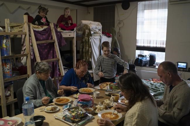Displaced people have lunch cooked by volunteers, at a restaurant that was transformed into a shelter for those who are fleeing the war from eastern region of the country, in Dnipro, Ukraine, Wednesday, April 20, 2022. The U.N. refugee agency says more than 5 million refugees have fled Ukraine since Russian troops invaded the country. The agency announced the milestone in Europe's biggest refugee crisis since World War II on Wednesday, April 20, 2022. (AP Photo/Leo Correa)