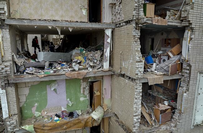 Firefighters work inside a building destroyed by a Russian bomb in Chernihiv on Friday, April 22, 2022. (AP Photo/Emilio Morenatti)