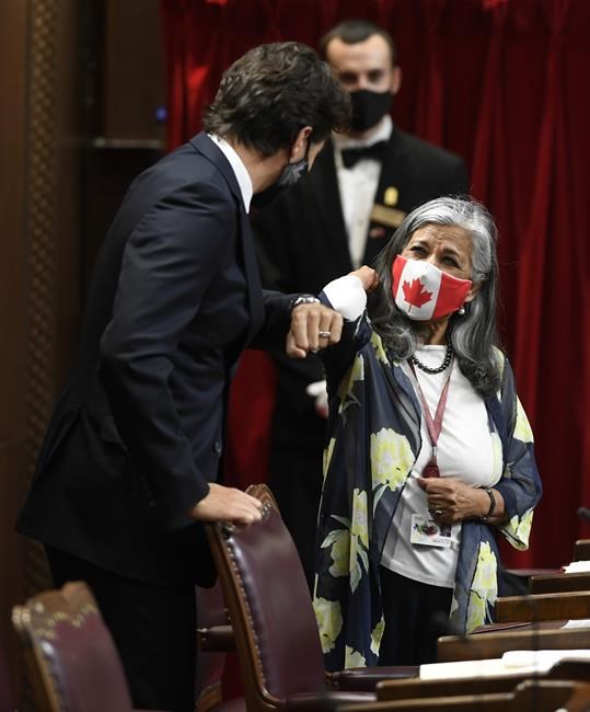 Prime Minister Justin Trudeau shares an elbow bump with Sen. Ratna Omidvar prior to the throne speech in the Senate chamber in Ottawa on Wednesday, Sept. 23, 2020. The independent senator is calling on the House of Commons to fast-track a new law she is proposing to confiscate the billions of dollars of frozen Russian assets and use them to rebuild Ukraine.THE CANADIAN PRESS/Adrian Wyld