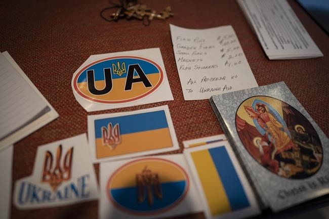 Stickers, booklets and magnets are seen on sale where proceeds would be donated to Ukraine Aid, Friday, April 22, 2022, during a Good Friday service at St. Mary's Ukrainian Orthodox Cathedral in Allentown, Pa.. While Easter is the most joyous of holy days on the church calendar, marking the day Christians believe Jesus triumphed over death, many members of Ukrainian Orthodox churches across the United States are finding it difficult to summon joy at a time of war. (AP Photo/Wong Maye-E)