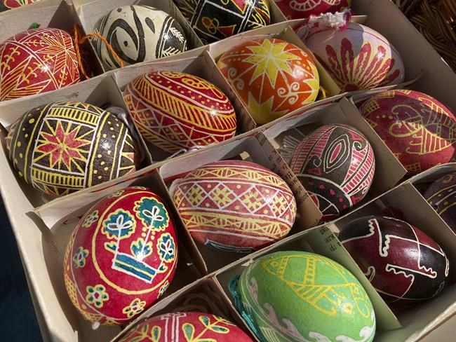 Orthodox Easter eggs are displayed on a sidewalk outside a cathedral in Kyiv, Ukraine, on Sunday, April 24, 2022. Ukrainians also marked two months since Russia’s invasion, praying for those on the front line and others trapped behind it. (AP Photo/Cara Anna)
