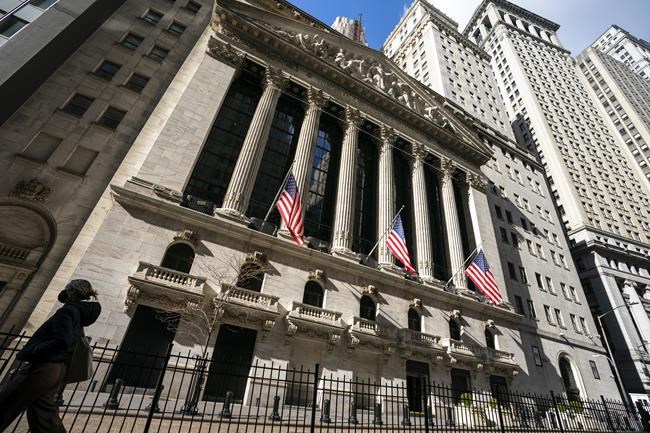 A pedestrian walks past the New York Stock Exchange, Monday, Jan. 24, 2022, in New York. Stocks are opening lower on Wall Street following drops in overseas markets, continuing a losing streak for U.S. markets that has brought the benchmark S&P 500 index down for three weeks in a row. Energy companies had the biggest losses in the early going Monday, April 26, 2022 as crude oil prices fell more than 5%. (AP Photo/John Minchillo)