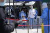 Residents line up for mass COVID-19 testing on Tuesday, May 3, 2022, in Beijing. China has stuck to its strict 