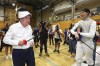 International Olympic Committee President Thomas Bach, left, gestures as he holds foil during fencing exhibition at the Olympics Unleashed session at the Yeronga Park Sports Centre in Brisbane, Australia, Saturday, May 7, 2022. Bach was in Brisbane on Saturday for the first time since the Queensland state capital was awarded the 2032 Olympics. (Jason O'Brien/AAP Image via AP)