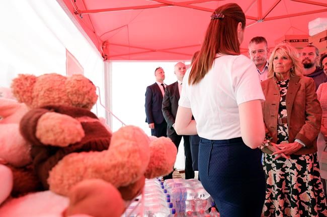 First lady Jill Biden listens as she visits a tent operated by Slovak Catholic charities with food and other supplies for refugees during trip to Vysne Nemecke, Slovakia, near the border with Ukraine, Sunday, May 8, 2022. (AP Photo/Susan Walsh, Pool)