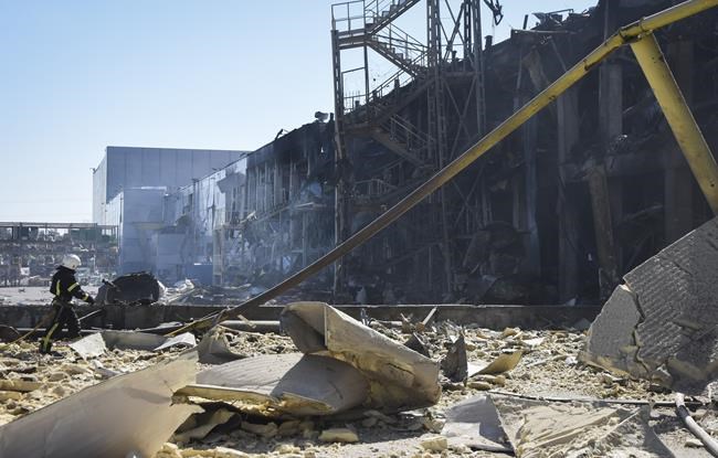 An Ukrainian firefighter works near a destroyed building on the outskirts of Odesa, Ukraine, Tuesday, May 10, 2022. The Ukrainian military said Russian forces fired seven missiles a day earlier from the air at the crucial Black Sea port of Odesa, hitting a shopping center and a warehouse. (AP Photo/Max Pshybyshevsky)